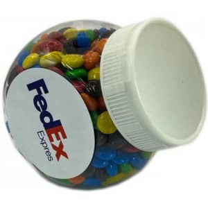 A clear plastic jar filled with colourful M&Ms, featuring a white lid and a logo on the side.