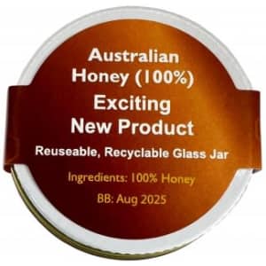 A glass jar of Australian honey with a brown and gold label, featuring a logo and recyclable details.