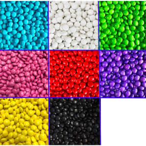 A grid of colourful chocolate beans in blue, white, green, pink, red, purple, yellow, black, and a blank section.
