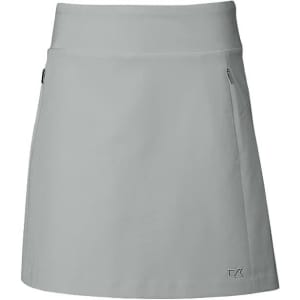 A grey skort with a flat waistband, featuring a side pocket and a small logo. Ideal for active wear.