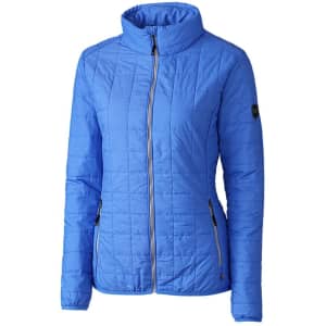 A blue ladies rain jacket featuring a zip front, high collar, and side pockets, with a logo on the sleeve.