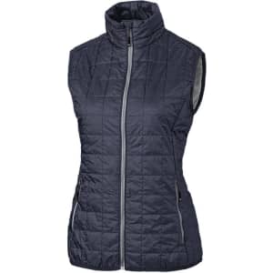 A dark grey puffer vest with a zip front and high collar, featuring two side pockets and a branding logo.
