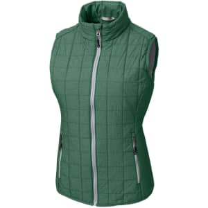 A green ladies' vest featuring a quilted design, zip front, and pockets. The vest has a branding logo.