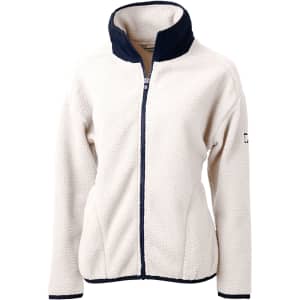 A cream-coloured eco-friendly Sherpa jacket with a navy collar, featuring a logo on the sleeve.