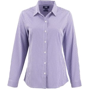 A ladies shirt in purple and white gingham check pattern with long sleeves and a button-down front, featuring a logo.