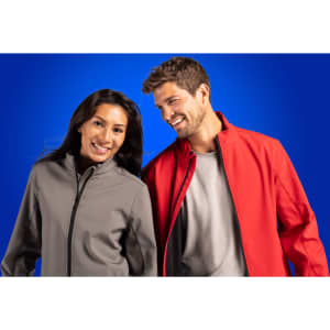 A grey and a red men's soft shell jacket are worn by two smiling individuals, set against a blue background.