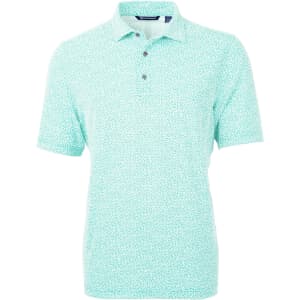 A mint green polo shirt featuring a botanical print and a logo on the chest. Short sleeves and two buttons at the collar.