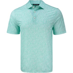 A light green polo shirt with a floral print and a three-button placket. It features a logo on the chest.