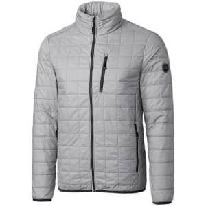 A grey, quilted rain jacket with a high collar and zippered pockets, featuring a logo on one sleeve.