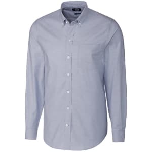 A light blue button-up shirt with long sleeves and a chest pocket, featuring a branded label.
