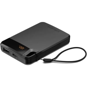 A black power bank with a built-in strap, featuring two USB ports and an LED indicator.