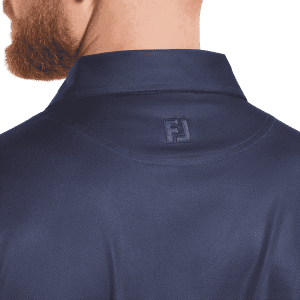 A navy blue polo shirt featuring a subtle dot print and a logo on the back collar.