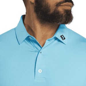 A men's polo shirt in light blue featuring a tonal dot print and a logo on the collar.