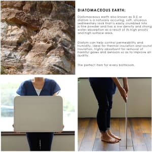 A light grey bath mat made from diatomaceous earth, with a sleek design and a subtle texture, featuring a logo.