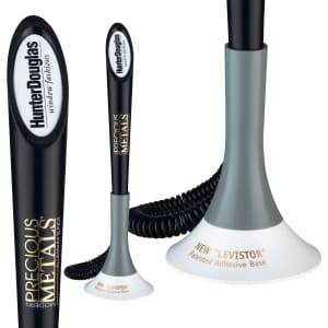 A black and grey writing pen with a curved design and a white adhesive base, featuring a logo.