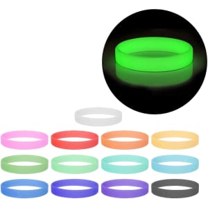 A collection of silicone wristbands in various colours, including a glowing green one, with a logo on some bands.