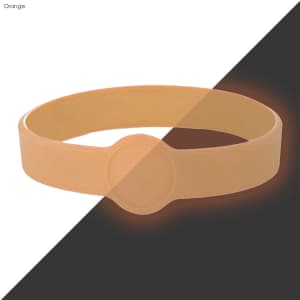 An orange silicone wristband with a flat surface, featuring a circular area, suitable for custom designs.