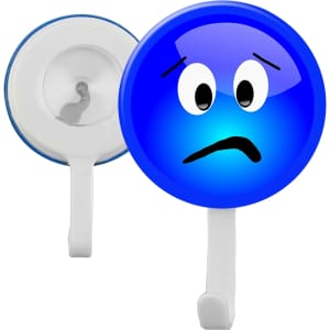 A blue button badge featuring a sad face design, with a white hook on the back and a branding logo.