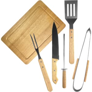 A BBQ set featuring wooden-handled tools: a spatula, tongs, a fork, a knife, and a sharpening rod, all on a wooden board.