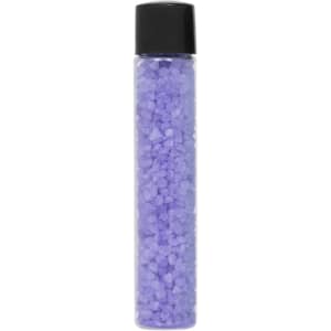 A clear bottle filled with purple bath salts, topped with a black lid.