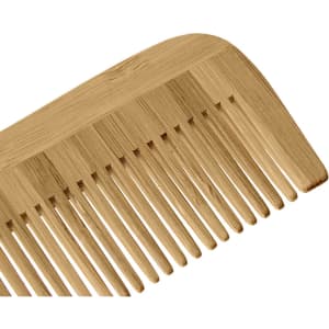 A bamboo comb in a light brown shade with a smooth finish and wide teeth, featuring a small logo.
