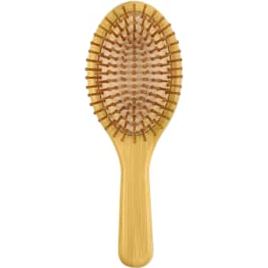 A bamboo hair brush in a light brown hue featuring a smooth handle and rounded bristles.