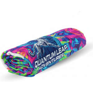 A rolled beach towel featuring vibrant pink, green, and blue colours with a logo.