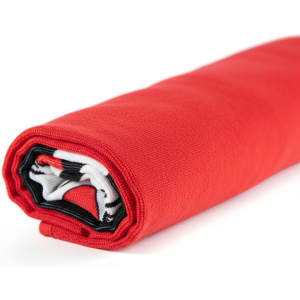 A rolled red beach towel featuring a black and white design, with a logo visible on one edge.