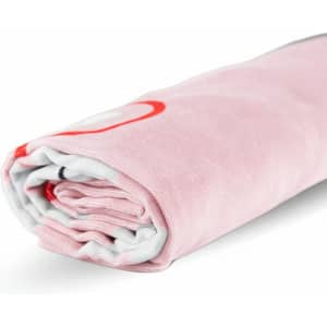 A rolled pink beach towel made of cotton, featuring a subtle pattern and a logo. It measures 80cm x 160cm.