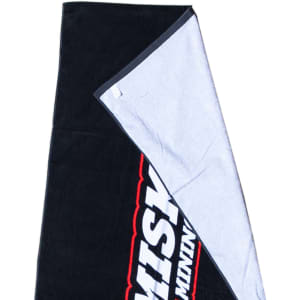 A black and grey beach towel featuring a soft cotton material and a logo on one side.