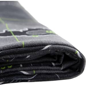 A folded grey beach towel featuring a design in green and white, with a logo visible on the fabric.