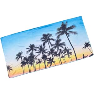 A beach towel in vibrant blue, featuring palm trees against a sunset backdrop. It has a logo in one corner.