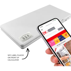 A silver calculator with an NFC label on the front, positioned beside a smartphone displaying a website.