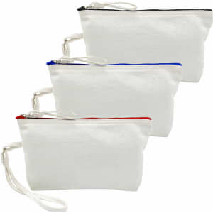 Three canvas cosmetic bags in white, each with a coloured zip (black, blue, and red) and a wrist strap.