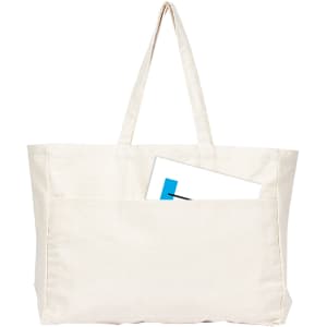 A large cream canvas tote bag with two handles and a front pocket, featuring an item partially tucked inside.