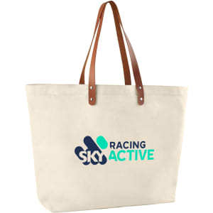 A cream cotton tote bag with brown leather handles and a logo printed on the front.