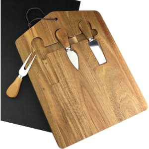 A wooden cheeseboard with three metal cheese knives and a black serving mat, featuring a handle and cut-outs for the knives.