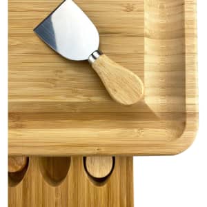 A bamboo cheeseboard featuring a metal cheese knife with a wooden handle, designed for serving cheese.
