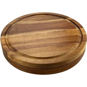 A wooden round cheeseboard featuring a smooth surface and a shallow groove along the edge, complete with a logo.