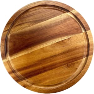 A round wooden cheeseboard with a smooth finish featuring a mix of light and dark wood tones.