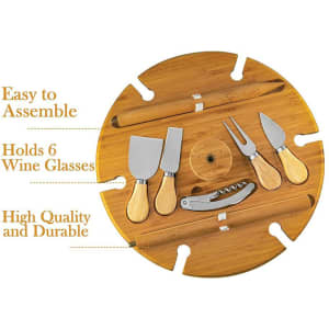 A round wooden table in natural colour with compartments for six wine glasses and various cheese knives. It features a branding logo.