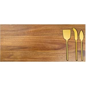 A wooden cheeseboard featuring three gold-coloured cheese knives. The board has a natural finish and smooth surface.