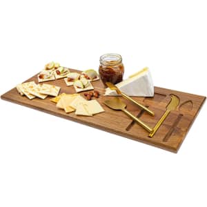 A wooden cheeseboard features a selection of cheeses, crackers, nuts, and a jar of jam, with gold knives included.