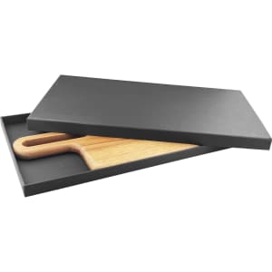 A wooden cheeseboard with a handle, presented in a sleek black box. The board features a natural finish.