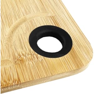 A bamboo cheeseboard with a circular black holder, featuring a smooth, natural finish.