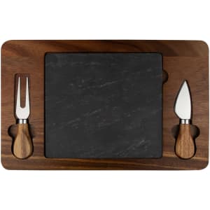 A wooden cheeseboard with a square slate surface, featuring two cheese knives with wooden handles.