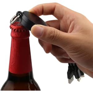 A drink bottle with a red label and a hand using a black bottle opener charging cable with multiple connectors.