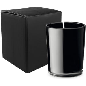 A black glass candle in a sleek holder, accompanied by a plain black box.