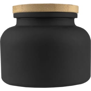 A black candle jar with a textured gold lid, featuring a round and smooth design. It has a simple, elegant appearance.