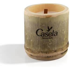 A bamboo candle in a natural wood holder featuring a wooden wick, with a logo on the side.